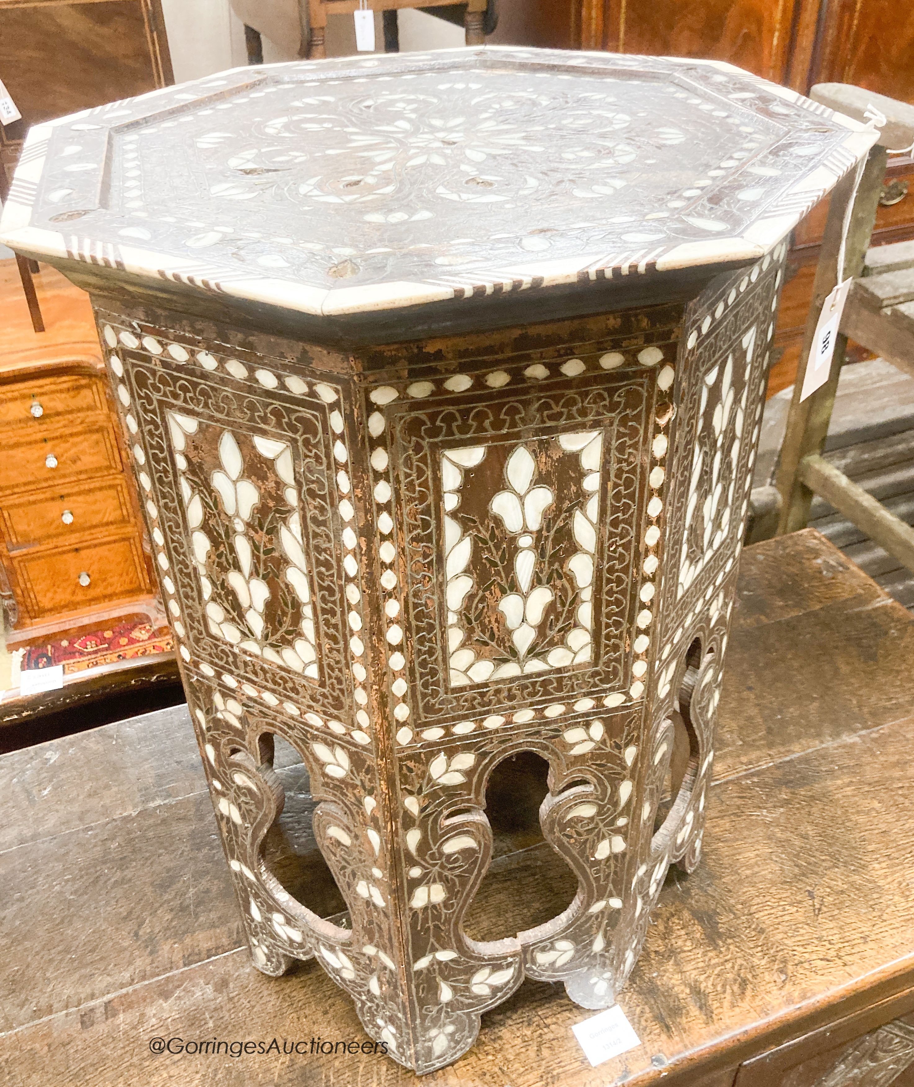 A Middle Eastern mother of pearl and bone inlaid octagonal topped coffee table, width 45cm, height 60cm